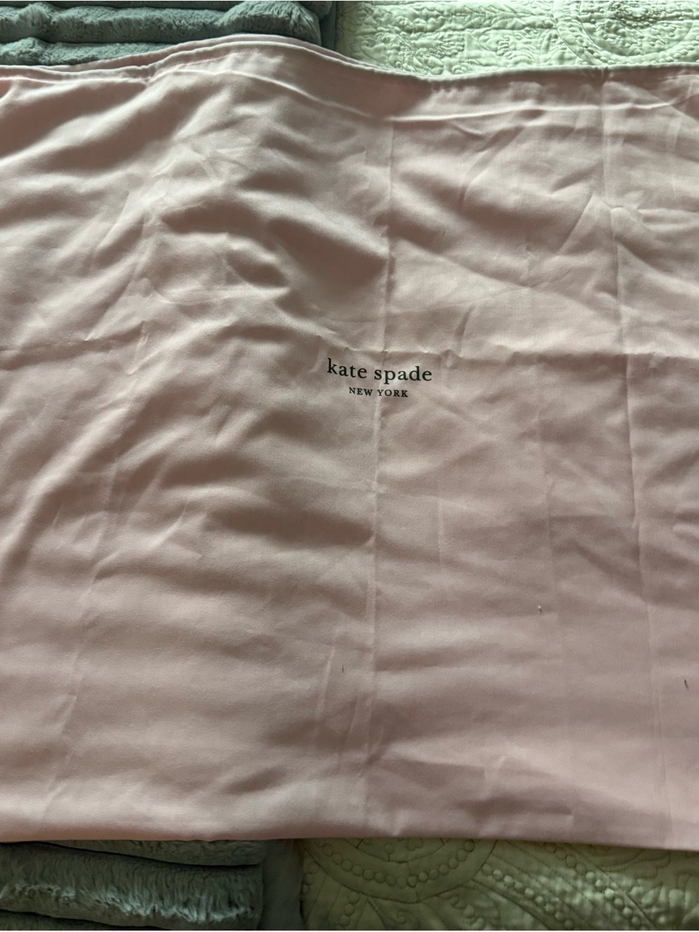 kate spade light pink dust bag with black logo